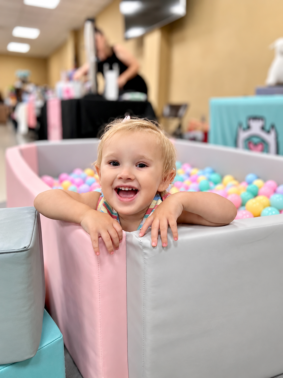 Kids laughing and playing in a pastel Little Harts ball pit