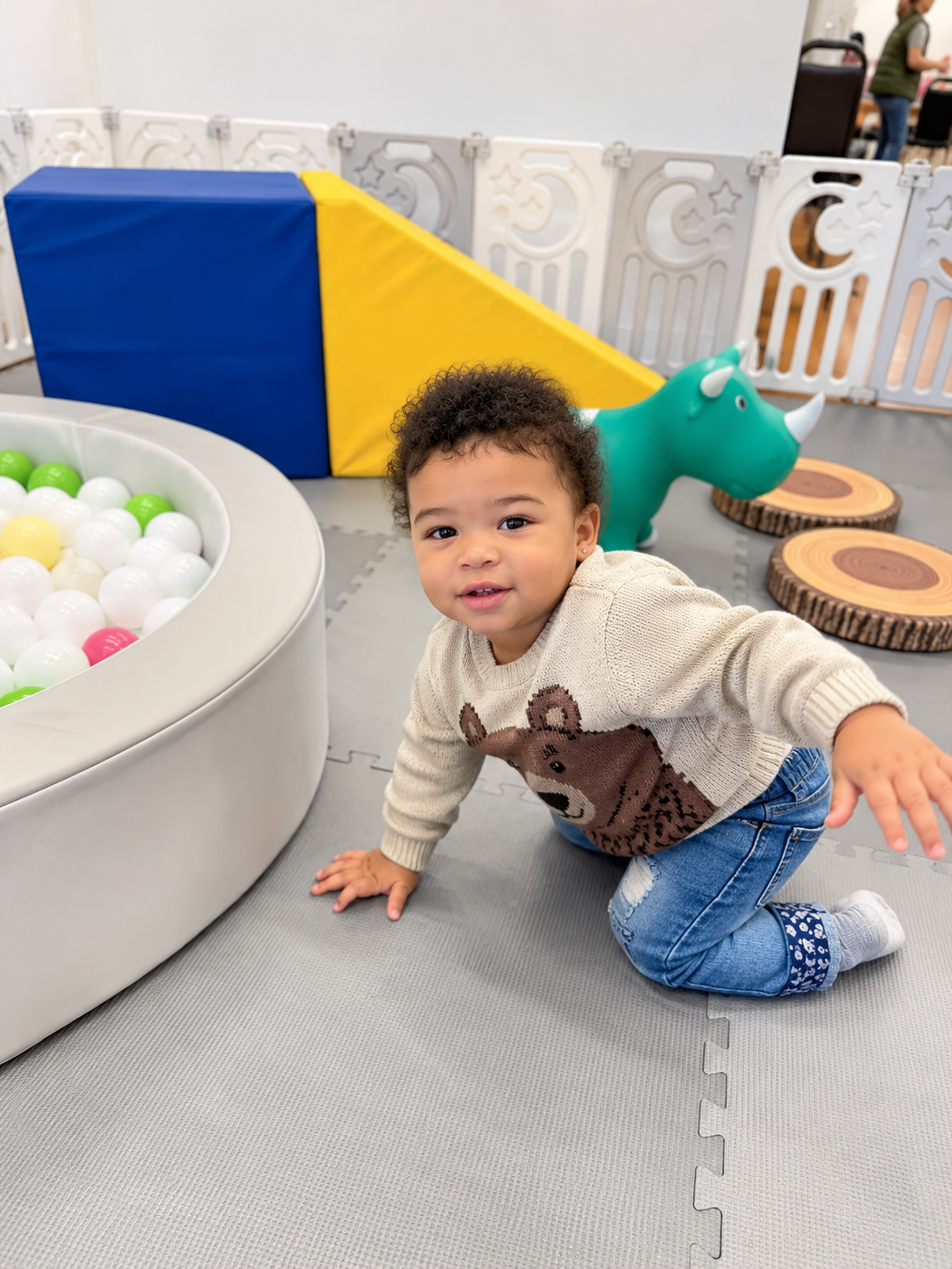 A little boy playing on the mats beside a Little Harts ball pit
