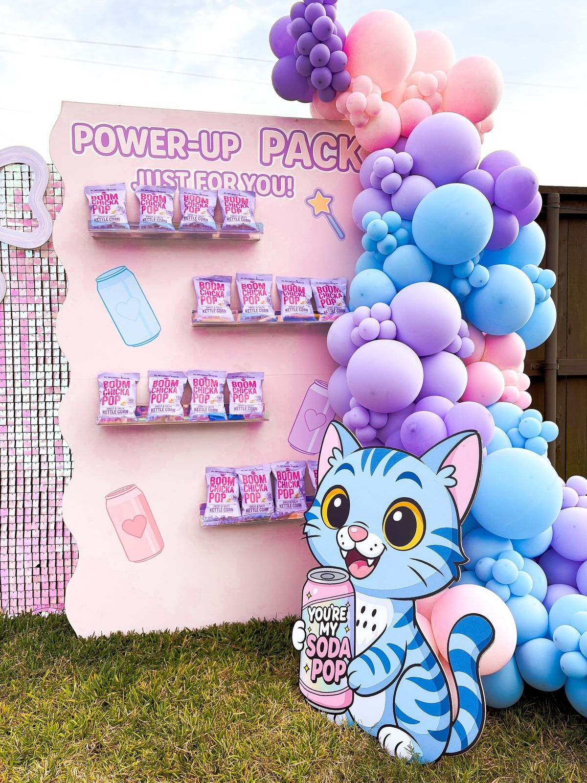 Pink, lavender and blue balloon-framed party favor display